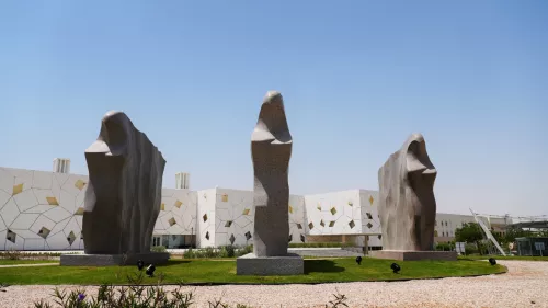 QF has unveiled artwork titled “Azzm” consisting of three granite sculptures depicting local women wearing abayas and battoulahs 